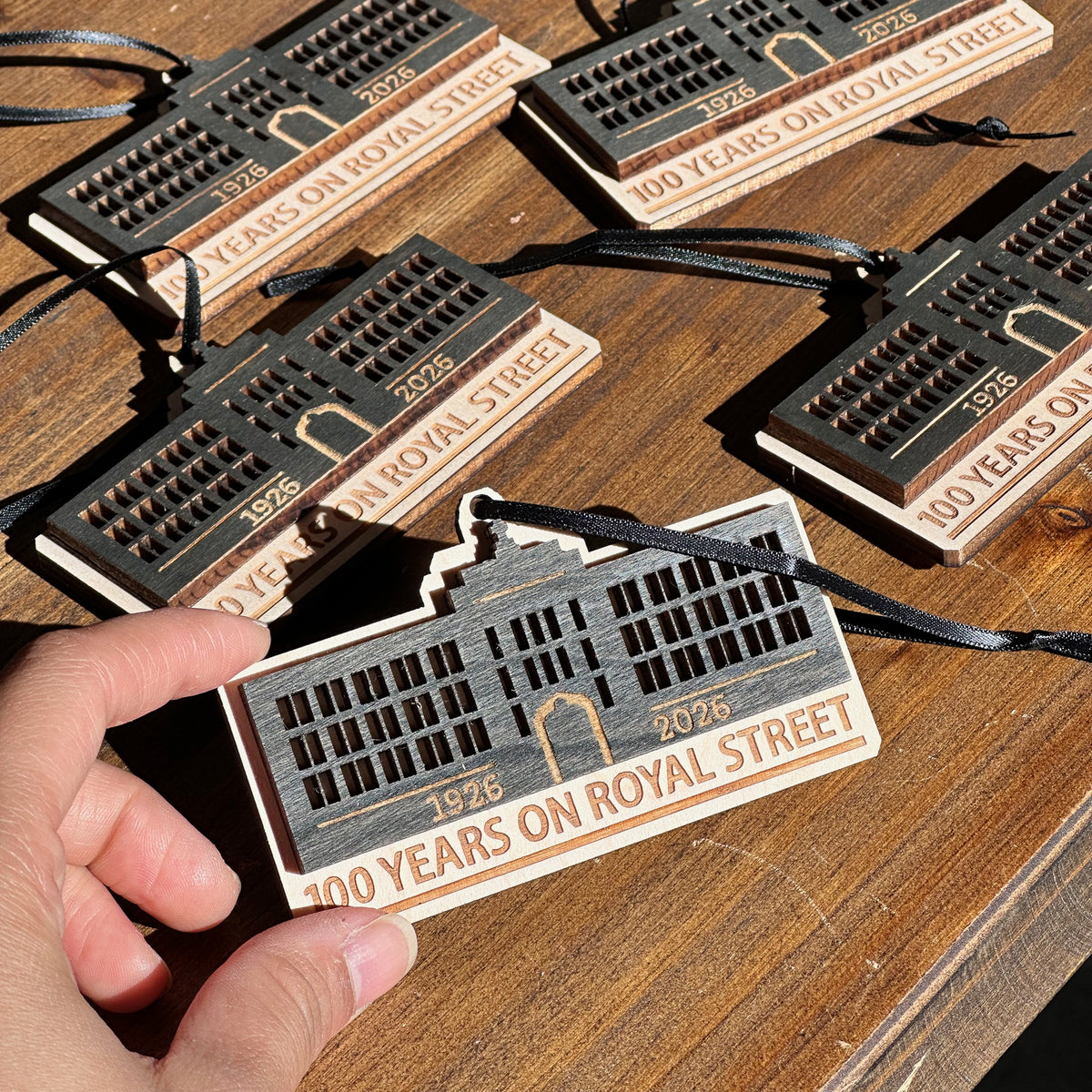 Layered building ornaments commemorating 100 years on Royal Street, photographed as a matching order