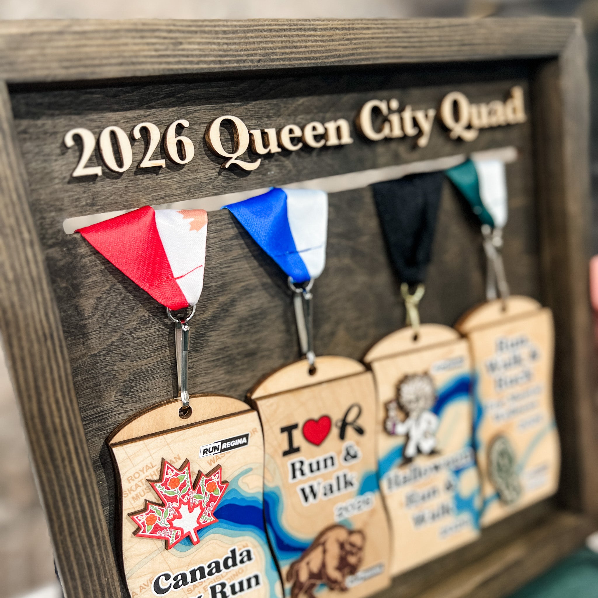 2026 Run Regina Queen City Quad Medal Display